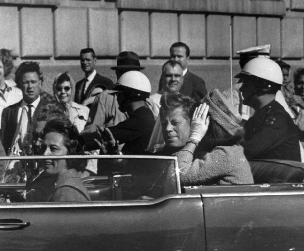 President John F. Kennedy riding in motorcade with first lady Jacqueline Kenndy in Dallas
