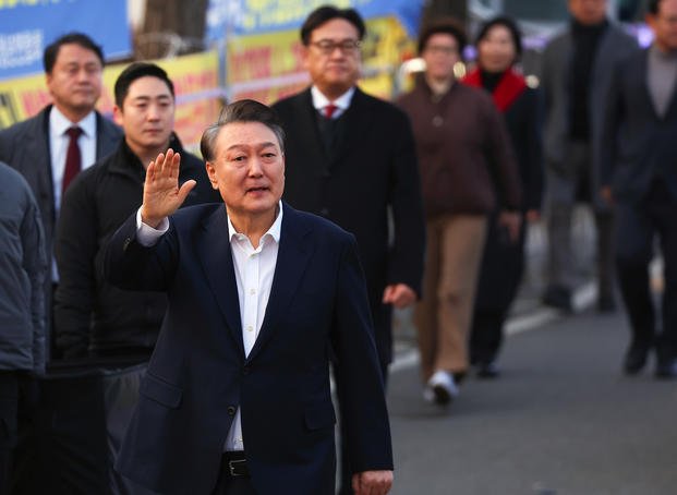 Impeached South Korean President Yoon Suk Yeol greets his supporters after he came out of a detention center