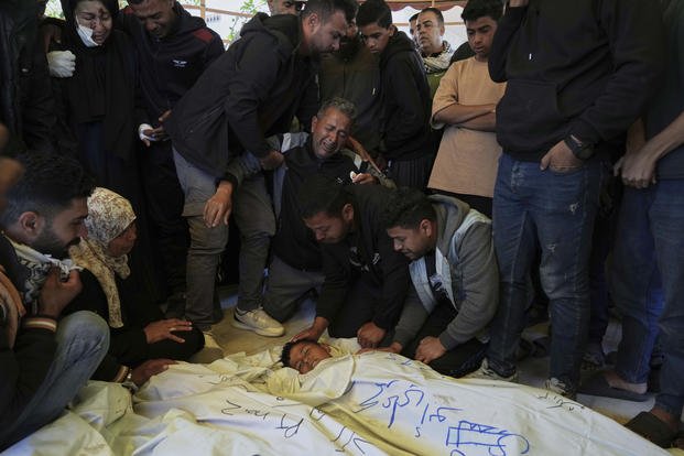 Mourners grieve over the body of Palestinian child 