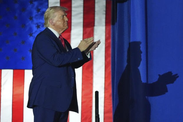 President Donald Trump arrives to speak on his first 100 days at Macomb County Community College Sports Expo Center