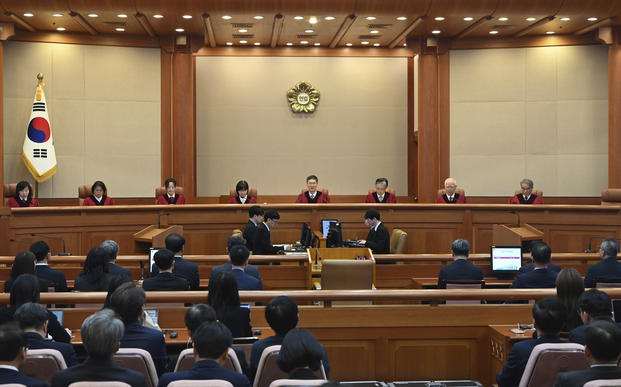 Moon Hyung-bae, center, acting chief justice of South Korea's Constitutional Court, speaks