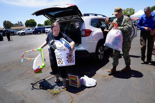 Courtney Bouma, a Navy dependent, arrives with items to be used for those who were evacuated after a small plane crashed early Thursday morning, May 22, 2025, in a heavily military community near San Diego, killing 6 and injuring 8.