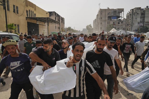 Palestinians carry the bodies of their relatives killed in an Israeli army airstrike.
