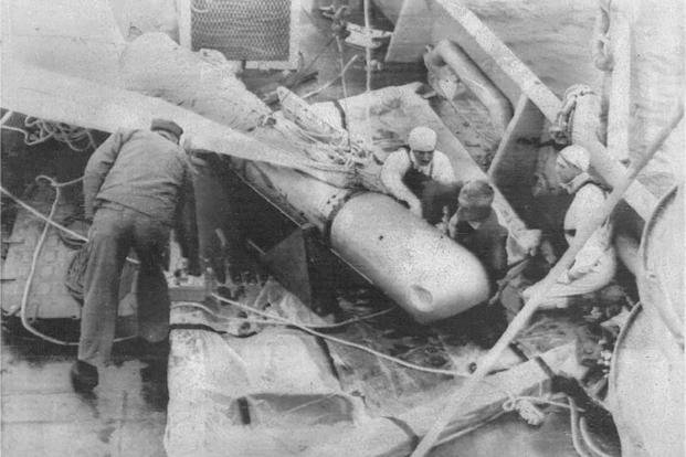 A hydrogen bomb rests aboard the USS Petrel after it is recovered from the Mediterranean Sea in April 1966. The bomb was lost after a midair collision involving a B-52 bomber and a KC-135 Stratotanker in January of that year. 
