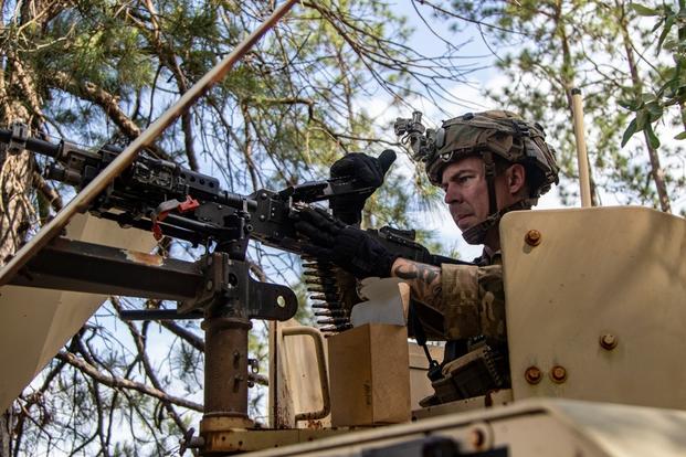 A U.S. Army advisor assigned to 2nd Battalion, 1st Security Force Assistance Brigade, loads ammo into a machine gun during a Joint Readiness Training Center rotation at Fort Polk, La., April 25. (Photo by Maj. Jason Elmore)