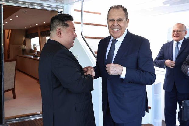 Russian Foreign Minister Sergey Lavrov shakes hands with North Korea's leader Kim Jong Un