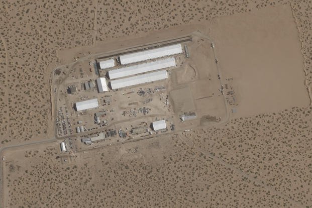 construction of large white tents for a new immigrant detention center at Fort Bliss