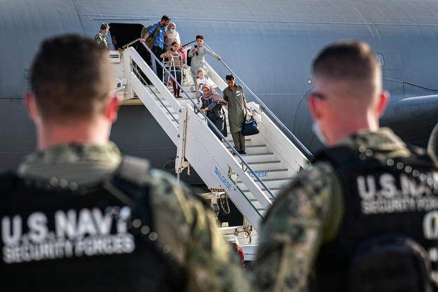 Afghan evacuees exit a U.S. Air Force C-17 Globemaster III at NAS Sigonella