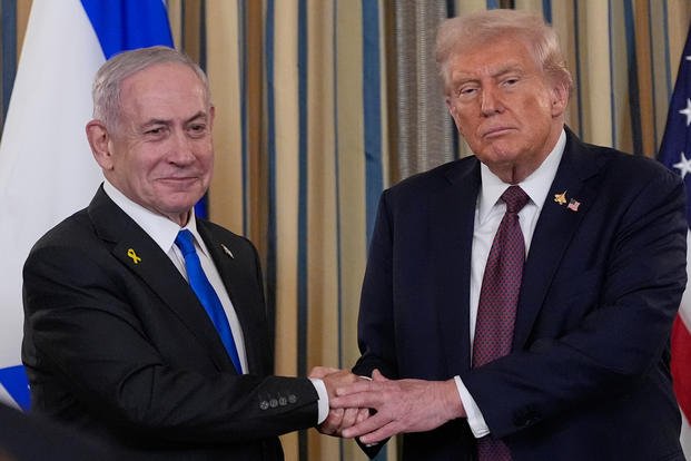 Israel Prime Minister Benjamin Netanyahu shakes hands with President Donald Trump.