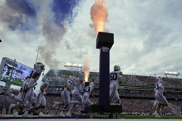 Kansas State players run onto the field before an NCAA college football game against North Dakota.
