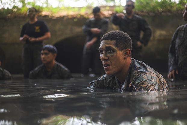U.S. Marine Corps Cpl. Isaac Koma, fixed wing airframe mechanic, Marine Fighter Attack Squadron 312, Marine Aircraft Group 31, 2nd Marine Aircraft Wing, prepares to grapple in shallow water during a culminating event at Marine Corps Air Station Beaufort, South Carolina.
