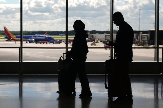 Travelers walk through the Baltimore/Washington International Thurgood Marshall Airport