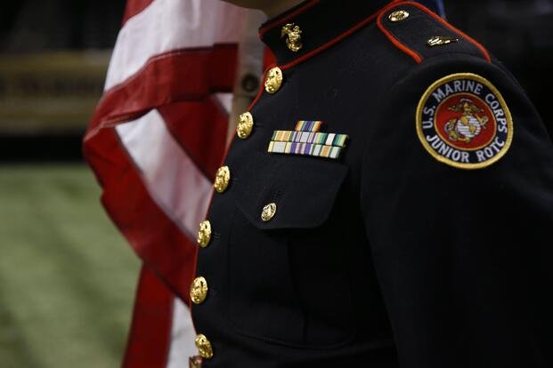 Members of the New Orleans Military and Maritime Academy honor guard rehearse with American flags as part of Salute to Service Month before an NFL football game between the New Orleans Saints and the Tennessee Titans in New Orleans, Sunday, Nov. 8, 2015. (AP Photo/Jonathan Bachman)