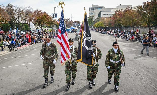 Veterans carry U.S. in a parade in California. 