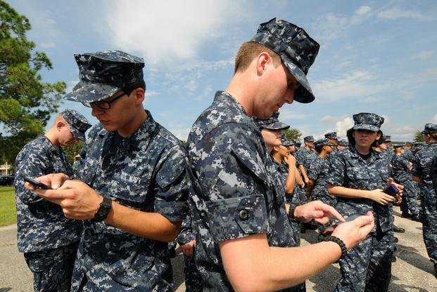 Navy members use cell phones
