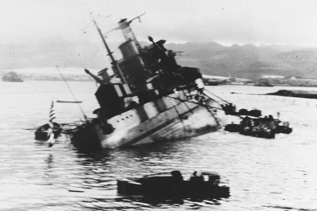 The USS Utah (AG-16) capsizing off Ford Island during the attack on Pearl Harbor, December  7, 1941. (U.S. Navy photo)