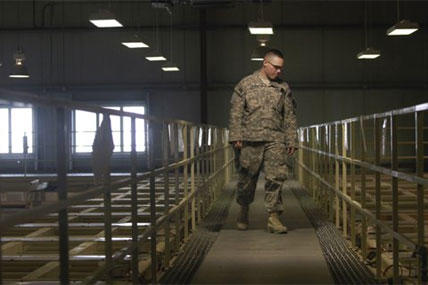 A U.S. military guard watches over detainee cells inside the Parwan detention facility near Bagram Air Field in Afghanistan. Saturday, March 23, 2013