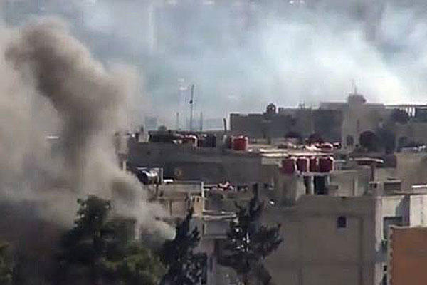 In this image taken from video obtained from the Shaam News Network, which has been authenticated based on its contents and other AP reporting, smoke rises from buildings due to heavy clashes between Free Syrian army fighters and government forces.