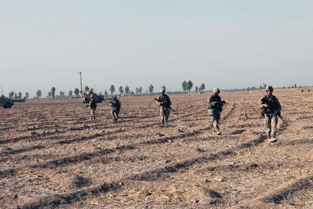 Infantry Marines with Bravo Company, 1st Battalion, 2nd Marine Regiment, look for suspicious activity during a security patrol in Helmand province, Afghanistan, Sept. 3, 2014. (U.S. Marine Corps photo by Cpl. Cody Haas/ Released)