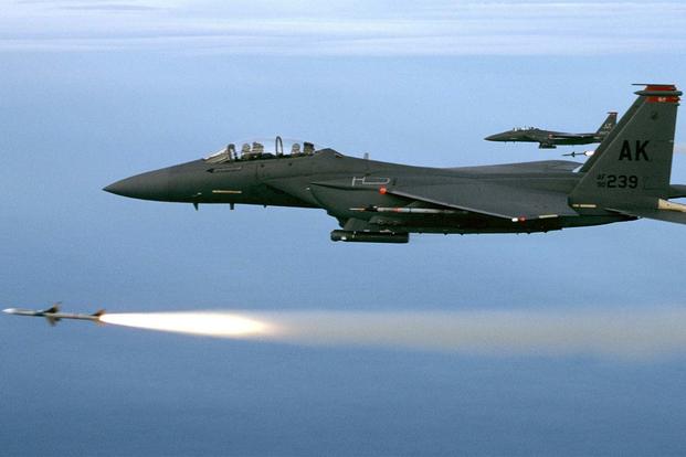 FILE -- Two F-15E from the 90th Fighter Squadron, Elmendorf Air Force Base, Alaska, fire a pair of AIM-7Ms during a training mission. The mission took place over the Gulf of Mexico just off the coast of Florida. (U.S. Air Force photo)