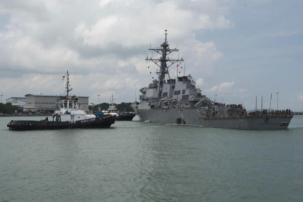 Tugboats from Singapore assist the guided-missile destroyer USS John S. McCain as it steers towards Changi Naval Base, Republic of Singapore following a collision with the merchant vessel Alnic MC on Aug. 21, 2017. (U.S. Navy photo/Joshua Fulton)