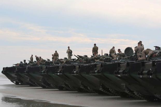 Marines with  2nd Assault Amphibian Battalion wait for final check of their assault amphibious vehicles before a training exercise on Onslow Beach at Marine Corps Base Camp Lejeune N.C. Aug. 17, 2015. U.S. Marine Corps/ Cpl. Preston McDonald)
