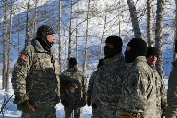Lt. Col. Mark Adams speaks with Gen. Vincent K. Brooks and Maj. Gen. Michael H. Shields about the importance of cold-regions training taking place during their visit to the Gulkana Glacier, March 10, 2015. (U.S. Army photo: Staff Sgt. Sean Callahan)