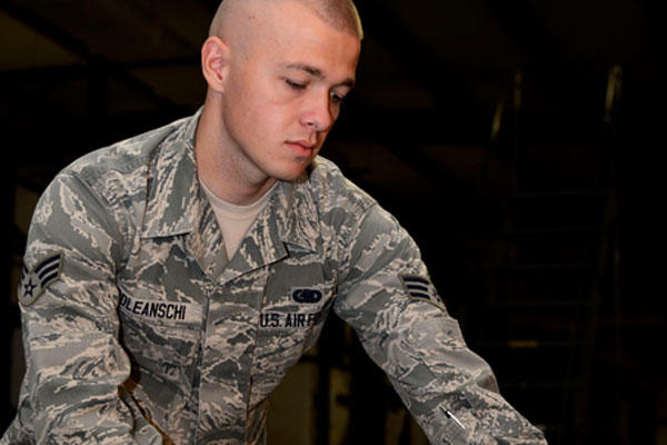 Senior Airman Vadim Poleanschi of the 386th Expeditionary Logistics Readiness Squadron disassembles an individual protective armor in Southwest Asia, June 3, 2015. (U.S. Air Force photo/Senior Airman Racheal E. Watson)