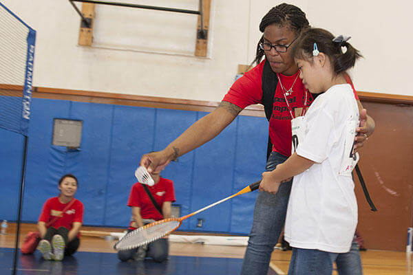 Airman 1st Class Amiya Jones, a 18th Security Forces Squadron armorer, helps Yuri Yonaha, a Kadena Special Olympics athlete, with her badminton skills during the games. (U.S. Air Force/A1C Lynette M. Rolen)