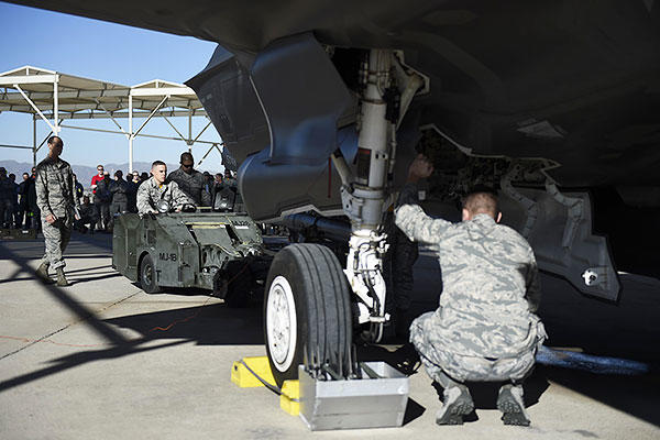 Weapons load crew members from the 61st Aircraft Maintenance Unit load an F-35A Lightning ll during a load crew competition Dec. 18, 2015, at Luke Air Force Base, Ariz. (U.S. Air Force photo/Staff Sgt. Staci Miller)