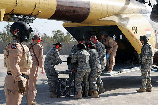 Members of the 332nd Expeditionary Medical Group unload a patient from an Iraqi helicopter during medical evacuation training for the Iraqi air force at Joint Base Balad, Iraq. (U.S. Air Force/Senior Airman Brittany Y. Bateman)