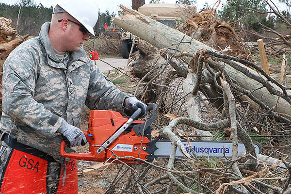 Virginia National Guard soldiers clear debris to open a blocked road in Essex County, Va.. More than 40 Virginia National Guard soldiers are on state active duty assisting with cleanup operations. (Virginia National Guard photo by Cotton Puryear)