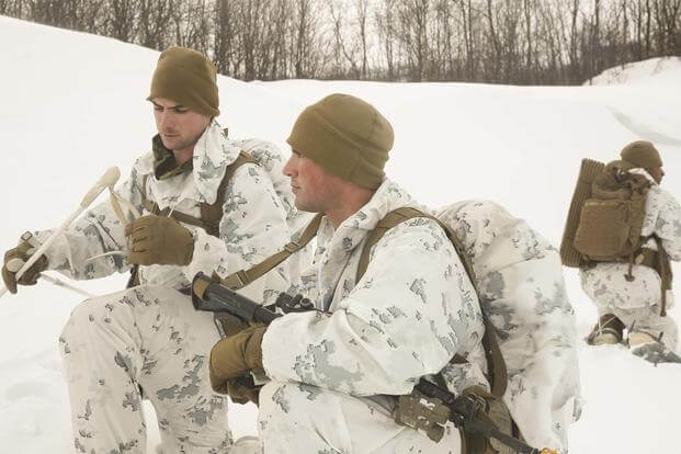 Cpl. Thomas Powers explains the next movement to Cpl. Greggory Williams while conducting a routine patrol during the final exercise of cold-weather training aboard Porsangmoen, Norway, Feb. 16-20, 2016. (Photo By: Cpl. Immanuel Johnson)