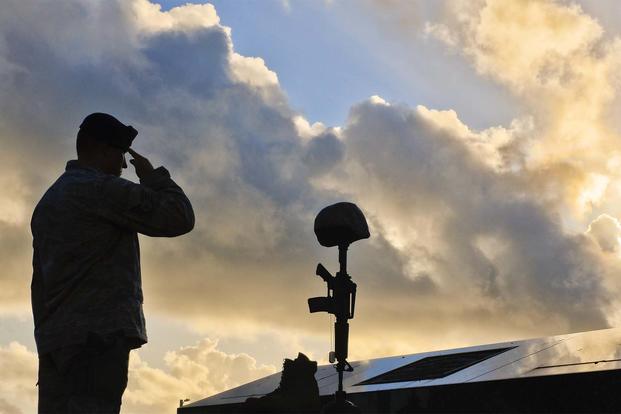 FILE - A Staff Sgt. salutes a fallen warrior memorial May 19, 2017, Andersen Air Force Base, Guam. (U.S Air Force/Airman 1st Class Christopher Quail)