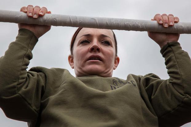 Major Misty Posey demonstrates proper form for pull-ups to Marines at Marine Corps Base Quantico, Virginia, Feb. 19, 2016. (Sgt. Dylan Bowye/U.S. Marine Corps)