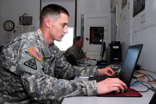 Army serviceman at a laptop
