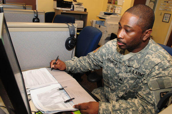 Soldier working at a desk.