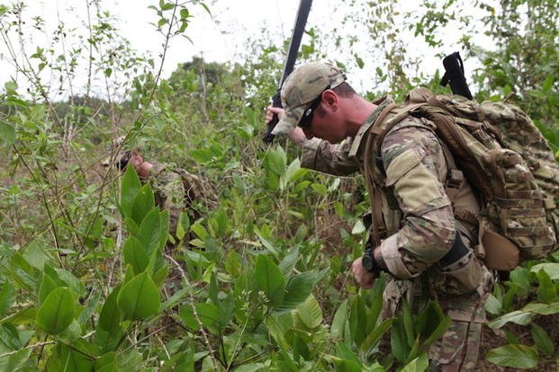 U.S. Army Staff Sgt. Michael Quinn (Right) and Sgt. Steven Ondrejech (Left) assigned to the Pathfinders from the 560th Battlefield Surviellance Brigade are using macheties to cut a path to plot points for an air drop in Douala, Littorall Region, Cameroon, Feb. 23, 2013. These Soldiers are apart of Central Accord to build a realtionship with the Cameroon Military and its partner nations. (U.S. Army photo by Sgt. Austin Berner/Not Released)