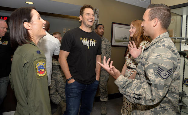 The Magnificent 7 movie actors Chris Pratt (center) and Haley Bennett (2nd,right) share a laugh with USAF Lt. Col. Jannell Macaulay (left) and an airman prior to a USO-sponsored film premiere at Joint Base McGuire-Dix-Lakehurst, New Jersey, September 18, 2016. The cast members and director toured the flightline, greeted service members and met with military families to extend their appreciation for their service. USO Photo by Mike Theiler