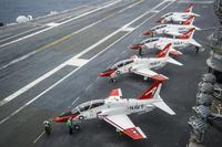 Pilots perform pre-flight procedures in T-45C Goshawks from Training Air Wing One 1 on the flight deck of the aircraft carrier USS George Washington on Dec. 10, 2016. The wing's Training Squadron 7 is on a stand-down after a crash that killed two. Petty Officer 2nd Class Bryan Mai/Navy