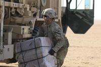 A soldier assigned to 215th Brigade Support Battalion, 3rd Armored Brigade Combat Team, 1st Cavalry Division, recovers a bundle off a drop zone during air drop resupply training July 27, 2017, at Udairi Range Complex, Kuwait. Staff Sgt. Leah R. Kilpatrick/Army