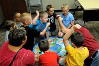 Children of military families celebrate after completing a puzzle during &quot;Kids Chat&quot;, a service provided by the Army's family advocacy program at Fort Carson, Colo. (US Army photo/Nathan Thome)