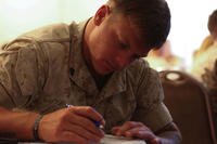 Marine Corps service member works on paperwork