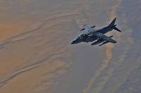 An AV-8B Harrier flies behind an aerial refueling plane above Africa in preparation for taking on fuel during an aerial refueling exercise Nov. 18, 2013. (USMC/SSgt. Matt. Orr)