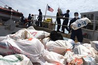 The crew of the Coast Guard Cutter Thetis offloads approximately 2,116 pounds of marijuana after returning to homeport in Key West, Florida, Friday, June 8, 2018. In March, Thetis crewmembers alongside an MH-65 Dolphin helicopter crew from Air Station Borinquen, Puerto Rico, and a Jamaican Defence Force crew interdicted a suspected drug smuggling vessel in the Caribbean. (U.S. Coast Guard photo/Ashley J. Johnson)