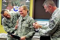 Newly promoted Tech. Sgt. Stacia Zachary, Team Eglin Public Affairs, receives her stripes from Col. Sal Nodjomian, 96th Air Base Wing commander, and Chief Master Sgt. Tom Westermeyer, 96th command chief Nov. 9, 2010. (U.S. Air Force/Chrissy Cuttita)