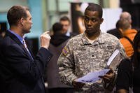 A transitioning soldier gets advice from a company recruiter at a Hire Our Heroes job fair.