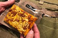 Staff writer Matthew Cox inspects and taste-tests the new MRE pizza, sent to Military.com by the Army’s Combat Feeding Directorate in Natick, Massachusetts. (Military.com/Hope Hodge Seck)
