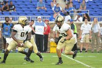 Cadet Kelvin Hopkins Jr., Army quarterback, fakes a handoff to running back Andy Davidson during the season-opening game against Duke University. (U.S. Army photo by Sgt. Brian Stephenson)