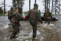 Marines with Marine Corps Base Camp Lejeune help push a car out of a flooded area during Hurricane Florence, on Marine Corps Base Camp Lejeune, Sept. 15, 2018. (U.S. Marine Corps/Lance Cpl. Isaiah Gomez)